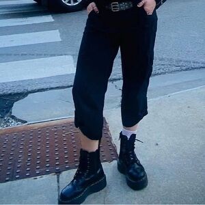 Black 3/4 pants with buttons on the bottom.